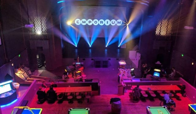 Emporium San Francisco: vibrant event space with stage, ideal for corporate events and gatherings.