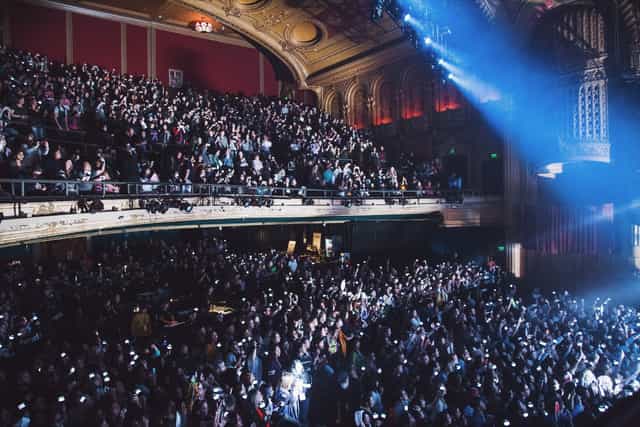 Packed auditorium at The Warfield, vibrant event with engaged audience and stage lights.
