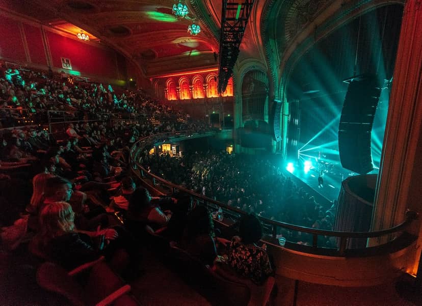 Vibrant theater event at The Warfield with dynamic lighting and engaged audience.