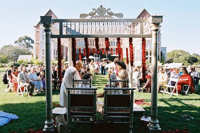 Outdoor wedding ceremony at Kohl Mansion with floral altar and elegant seating.