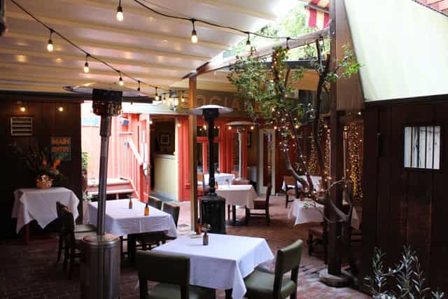 Charming outdoor event space with warm lighting for intimate gatherings and receptions.