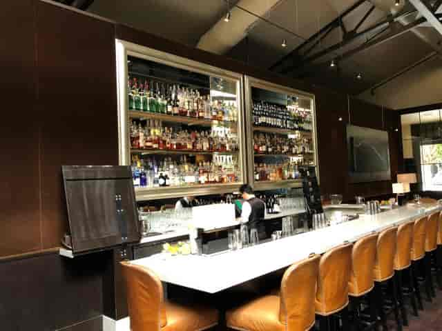 Sleek bar in Spruce with extensive spirits, ideal for networking events and cocktail receptions.