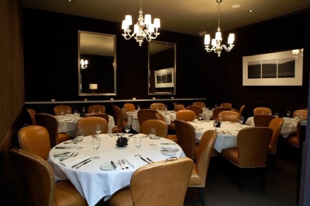 Elegant dining room with round tables, ideal for formal events and corporate dinners.