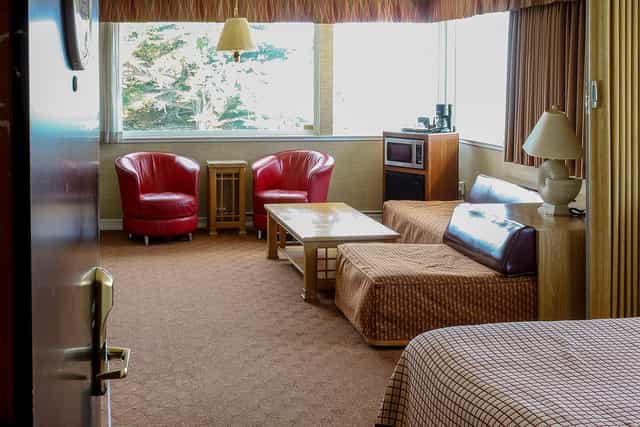 Cozy Sun Deck at Seal Rock Inn with red armchairs for networking and brainstorming.