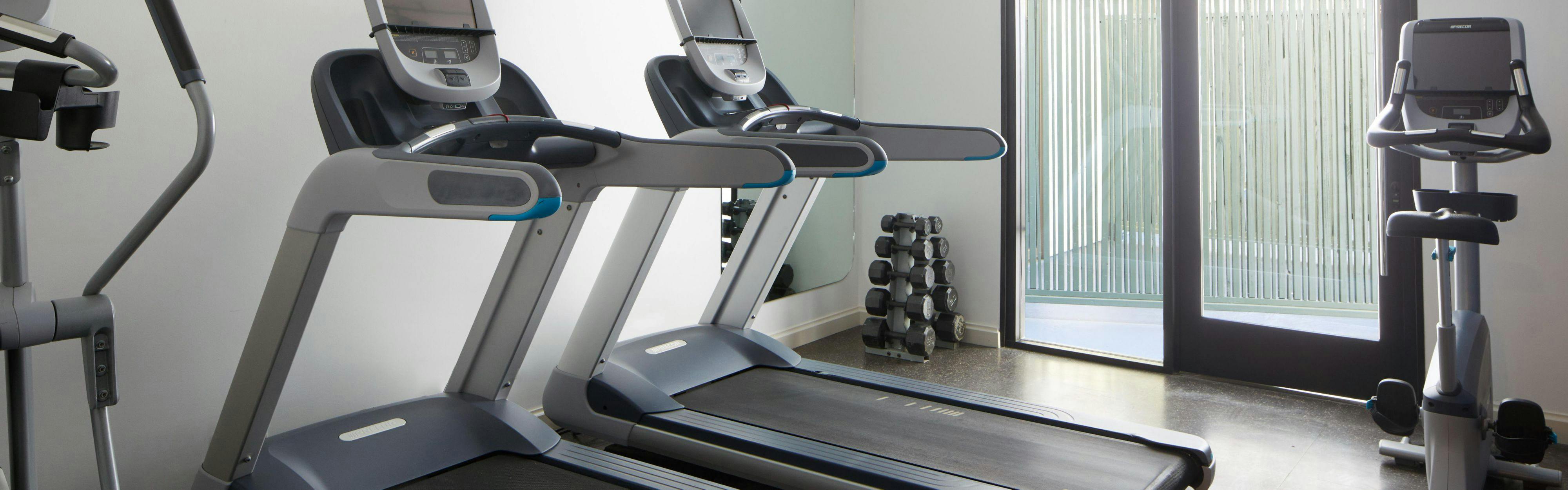 Modern fitness area with treadmills at Kimpton Hotel Enso for wellness events.