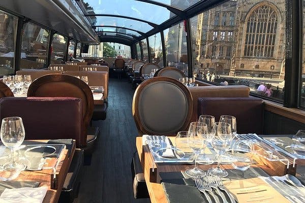 Stylish dining room on a double-decker bus for corporate events and private dinners.