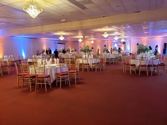 Elegant banquet room with white linens, ideal for weddings and corporate events.