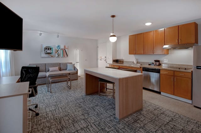 Modern kitchen and living area in Homewood Suites, perfect for meetings and networking.