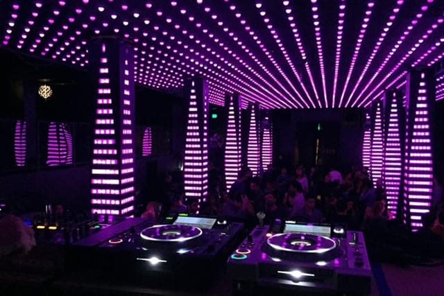 Vibrant Temple Nightclub Main Room with purple lighting, ideal for nightlife events and parties.