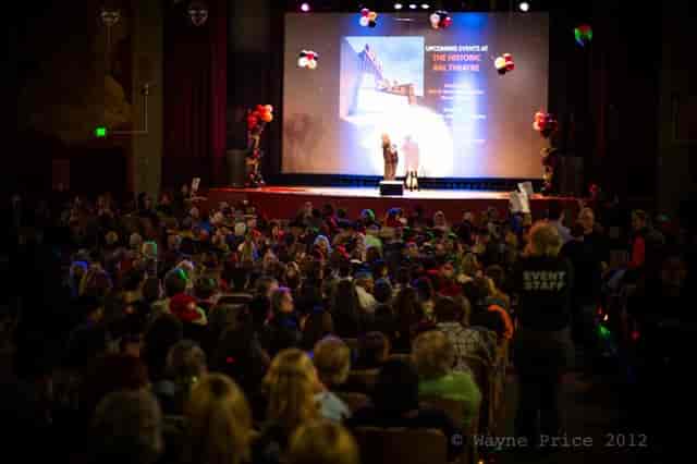 Historic BAL Theatre event with vibrant audience and colorful stage lighting.