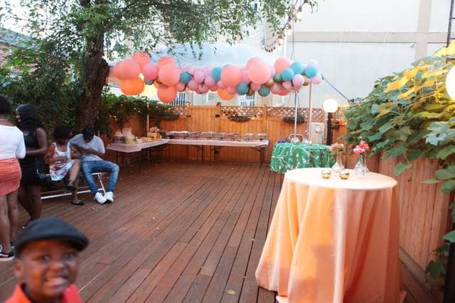 Charming outdoor event space in Brooklyn with vibrant balloon arch for celebrations.