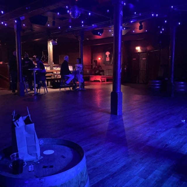 Main Stage at Neck of the Woods: cozy event space with warm lighting for gatherings.