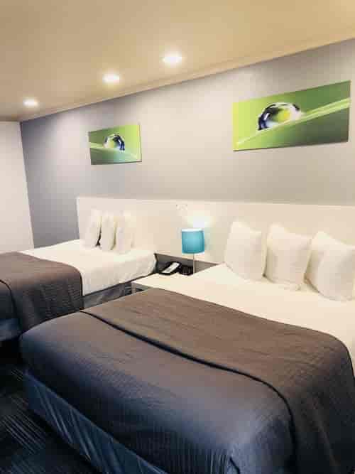 Hotel room with two beds at BridgePoint Inn, perfect for conference attendees.