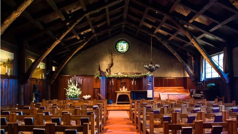 Historic Arts & Crafts Chapel with wooden beams, perfect for intimate ceremonies and gatherings.
