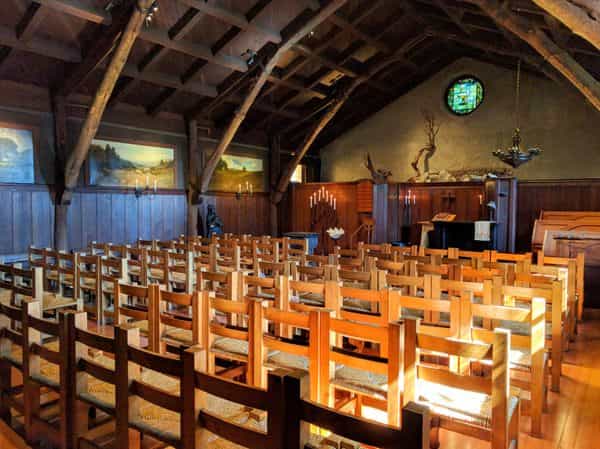 Historic Arts & Crafts Chapel with wooden beams, perfect for intimate ceremonies and gatherings.