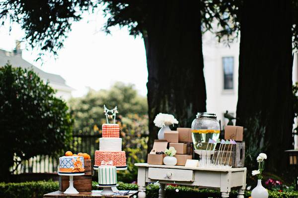 Luscious Garden wedding setup with tiered cake and floral accents in Swedenborgian Church.