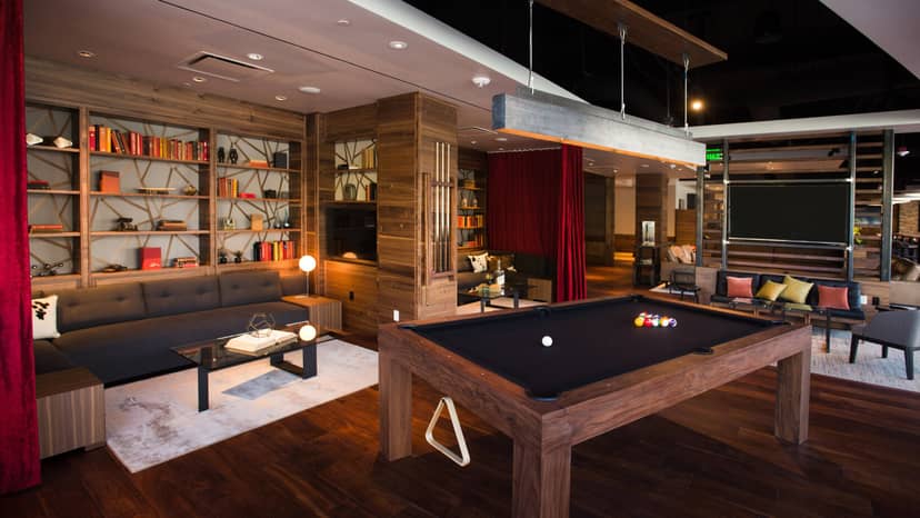 Stylish lounge at The Cove, ideal for networking events with pool table and warm wood accents.