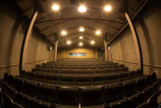Spacious auditorium with black seating, ideal for conferences and performances at Fort Mason.