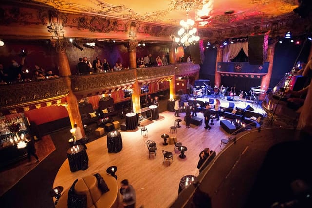 Elegant concert hall with ambient lighting, perfect for upscale events and live performances.