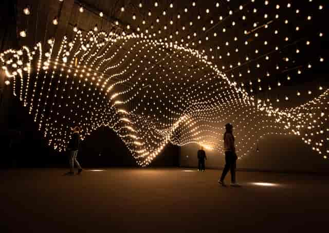 Artistic light installation in dynamic event space for creative gatherings.