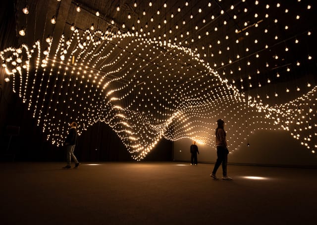Artistic light installation in dynamic event space for creative gatherings.