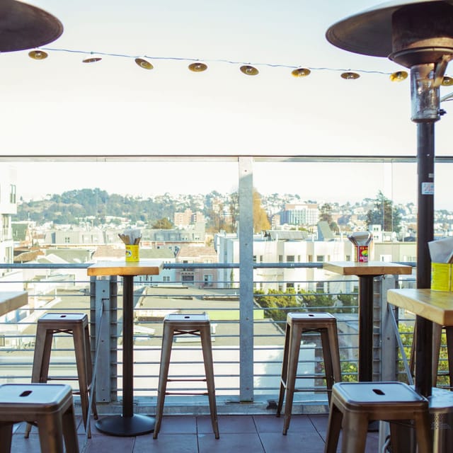 Stylish rooftop patio with city view, ideal for networking events and casual meetings.