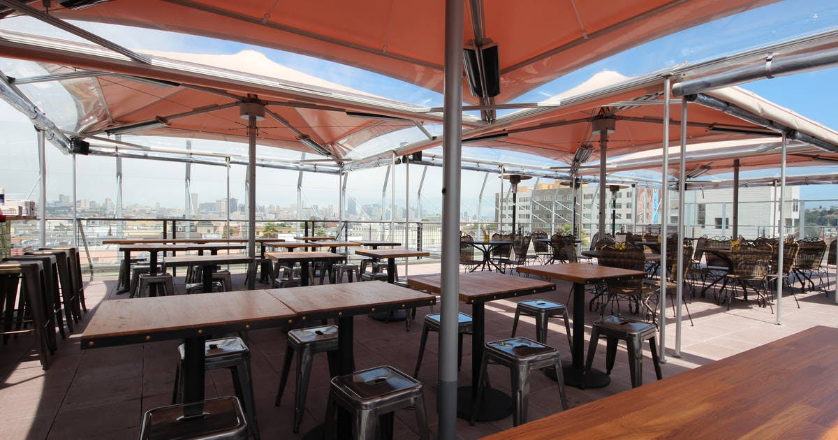 Rooftop patio venue with city views, ideal for networking events and receptions.