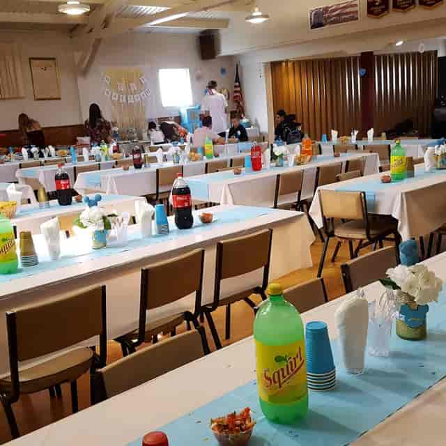 Banquet hall in Colombo Club with light blue tablecloths for community events.