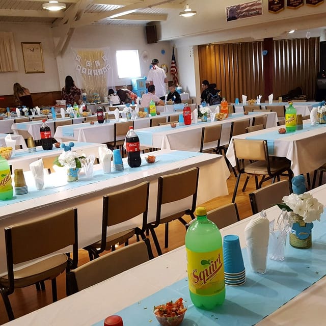 Banquet hall in Colombo Club with light blue tablecloths for community events.