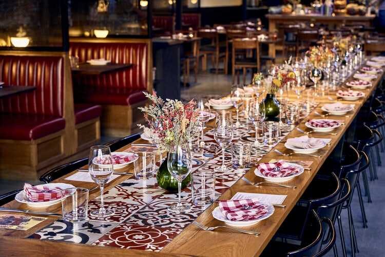 Elegant long dining table setup for corporate dinner at Che Fico Restaurant.
