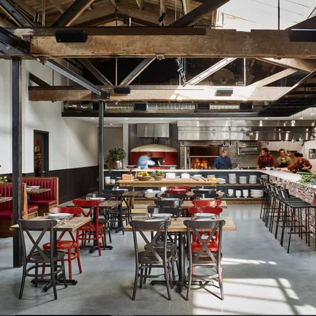 Private dining space at Che Fico Restaurant with rustic decor, ideal for events and gatherings.