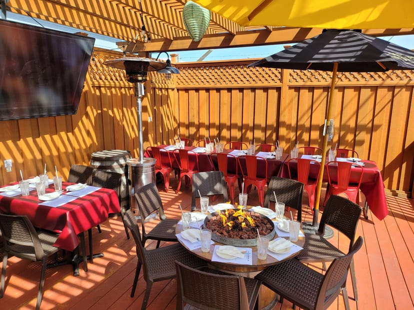 Outdoor dining at The Roadhouse with fire pit, ideal for events and gatherings.
