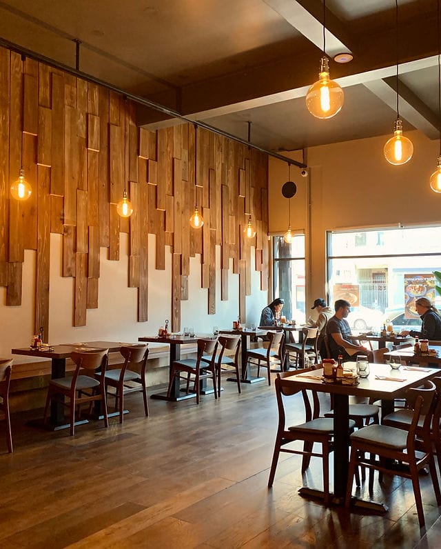 Cozy restaurant with wooden walls, ideal for casual events and team lunches.