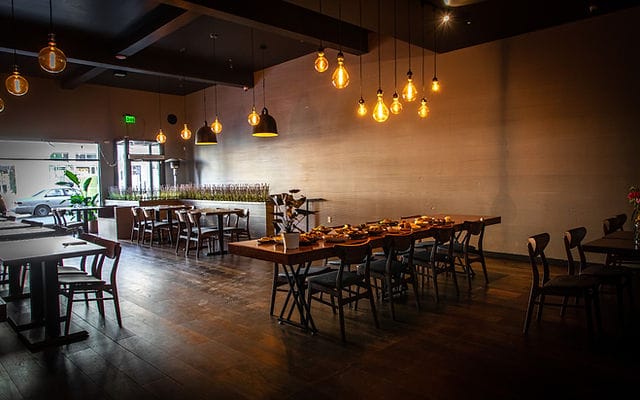 Modern restaurant event space with warm lighting and flexible seating for gatherings.