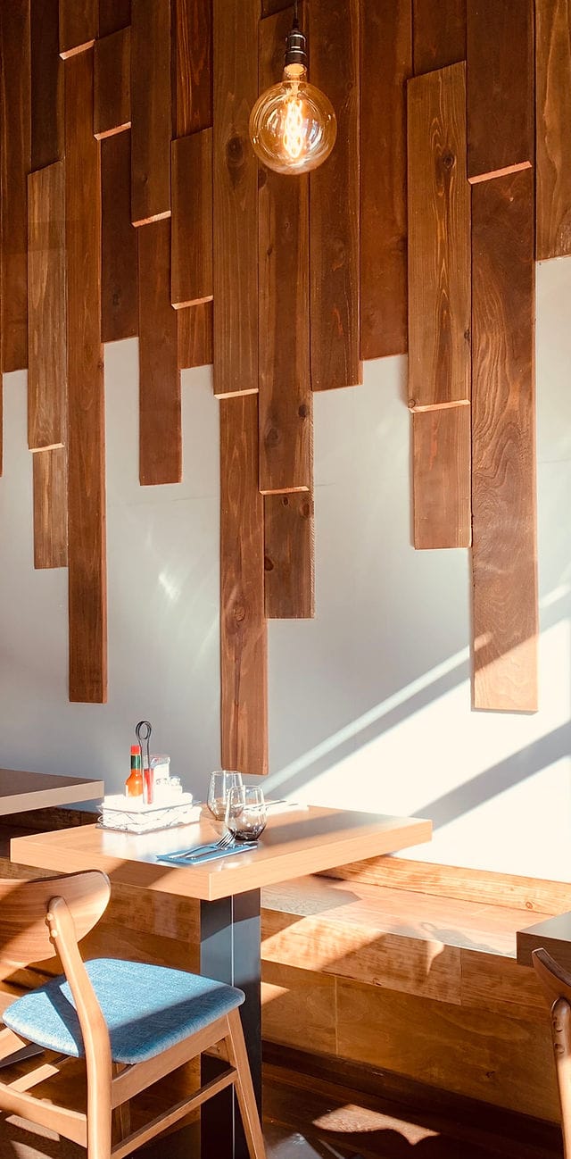 Modern restaurant event space with wooden panels, perfect for networking and gatherings.