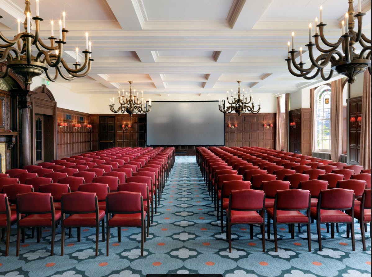 Elegant conference room with red chairs for events at University Arms Cambridge.