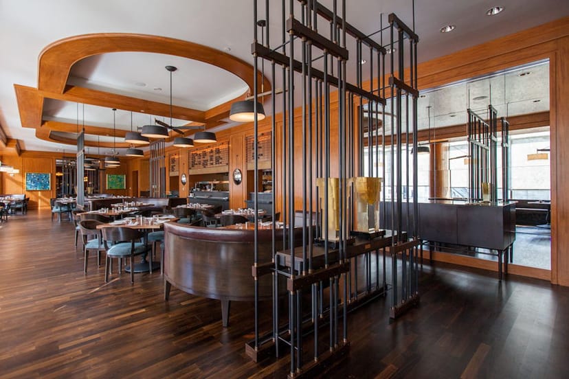 MKT Restaurant and Bar, modern event space with warm wood tones, ideal for upscale gatherings.