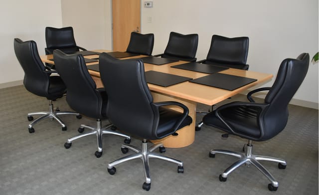 Modern Huntington Board Room with wooden table and ergonomic chairs for meetings.