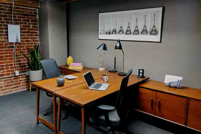 Modern day office for meetings in Trellis Coworking, featuring a warm brick wall.