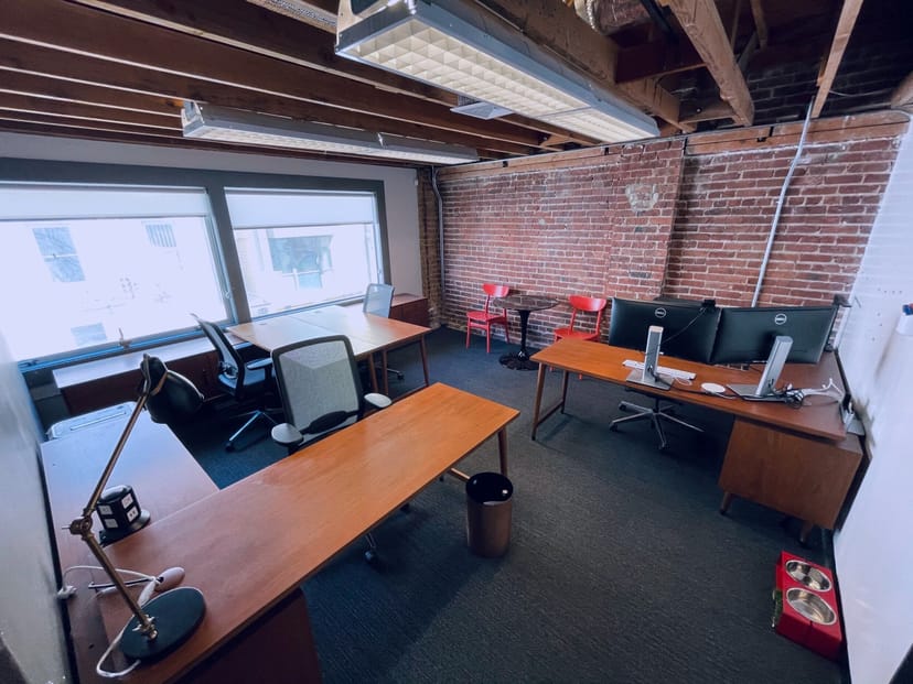 Day office for small meetings with natural light and exposed brick at Trellis Coworking.