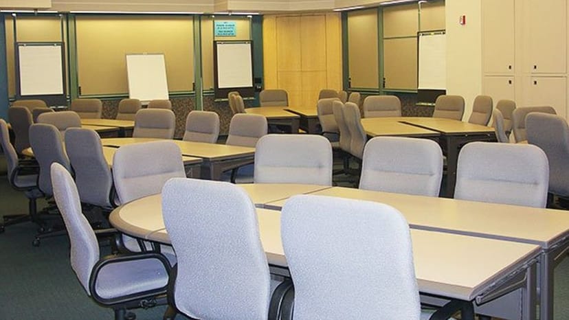 Versatile meeting room with round tables at AMA Conference Center, San Francisco for workshops.