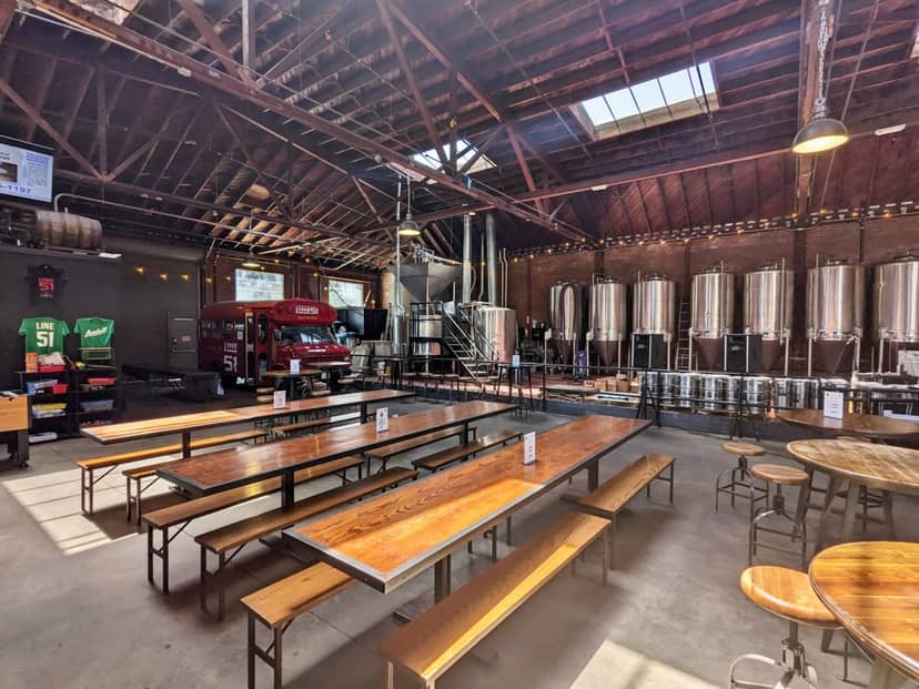 Spacious brewery venue with industrial decor, ideal for casual meetings and events.
