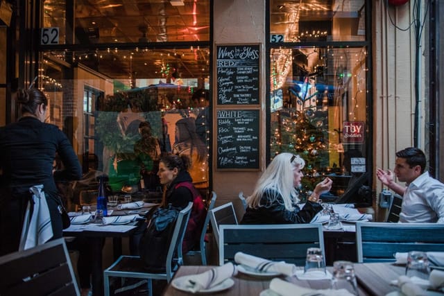 Vibrant patio dining setup with twinkling lights for intimate gatherings and events.