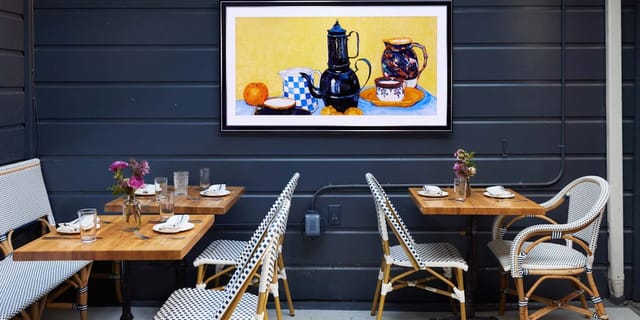 Communal table in Marlowe, warm decor for intimate gatherings and networking events.