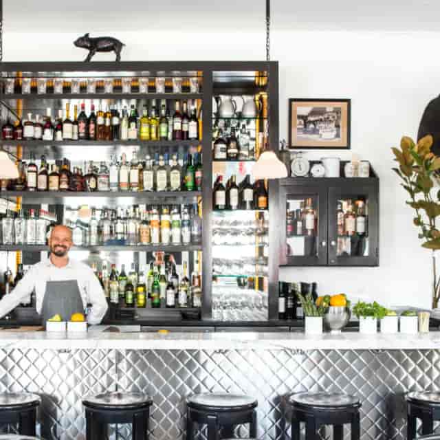 Inviting bar in Marlowe with friendly bartender, ideal for networking events and receptions.