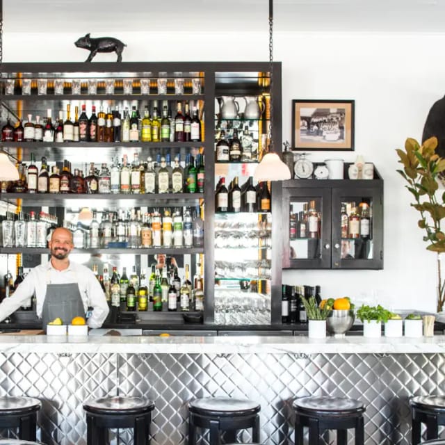 Inviting bar in Marlowe with friendly bartender, ideal for networking events and receptions.