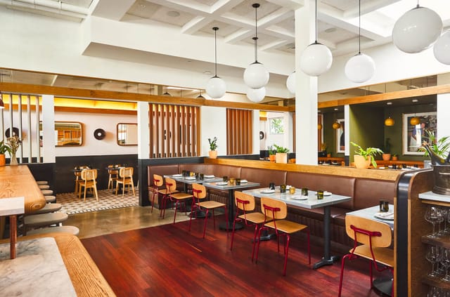 Modern Delfina Restaurant with vibrant seating, perfect for intimate meetings and events.