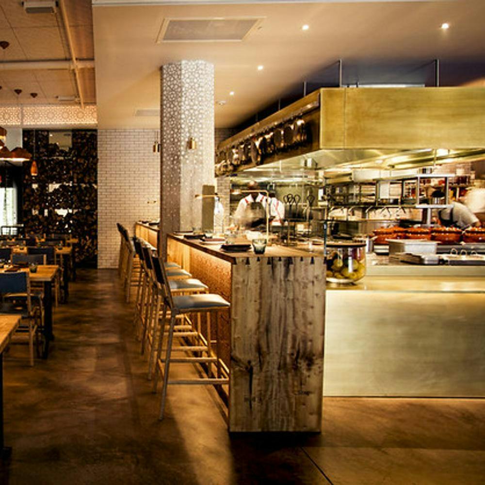 Modern Bellota SF restaurant with open kitchen, ideal for casual dining and events.