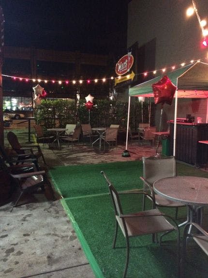 Heated patio at Mars Bar & Restaurant, cozy outdoor event space with string lights and balloons.