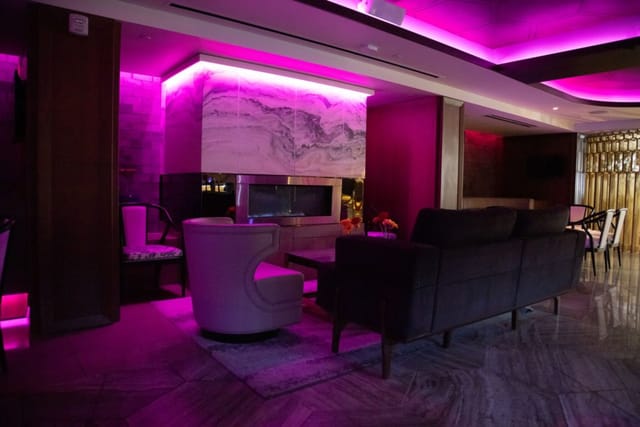 Stylish lounge area with purple lighting at Hotel Fusion for networking events.